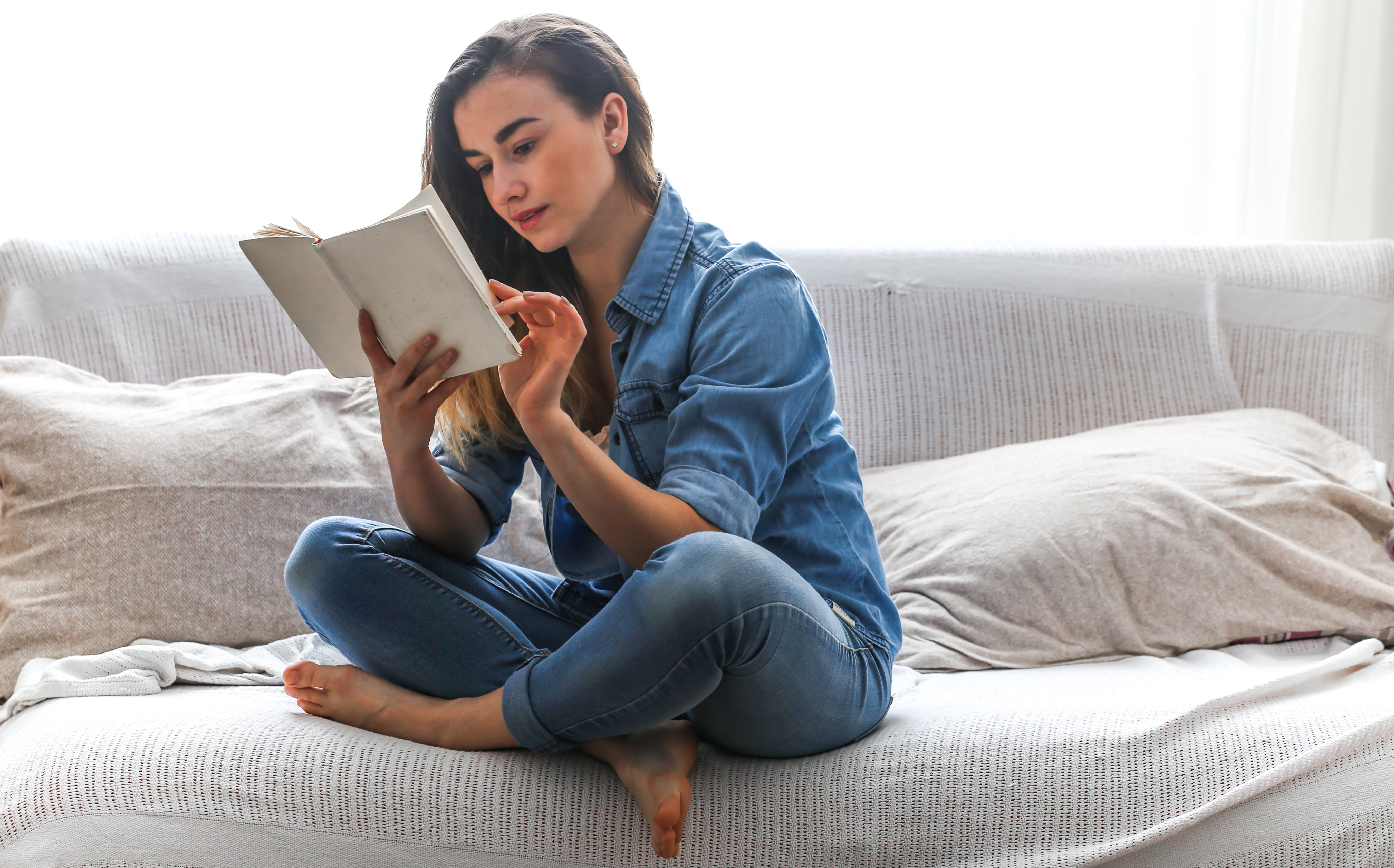 White,cozy,bed,and,a,beautiful,girl,,reading,a,book,