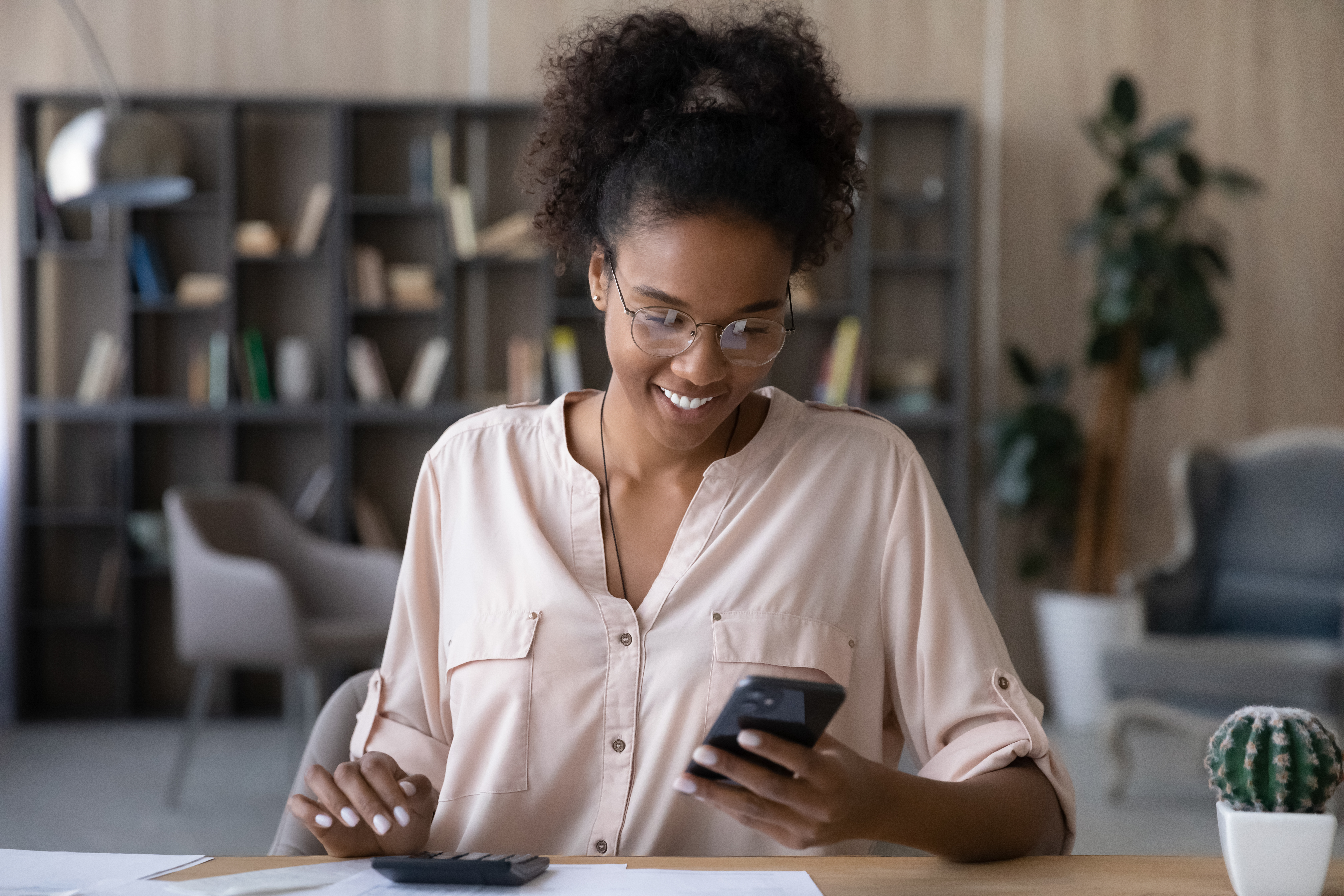 Happy,young,african,ethnic,woman,in,glasses,calculating,domestic,utility